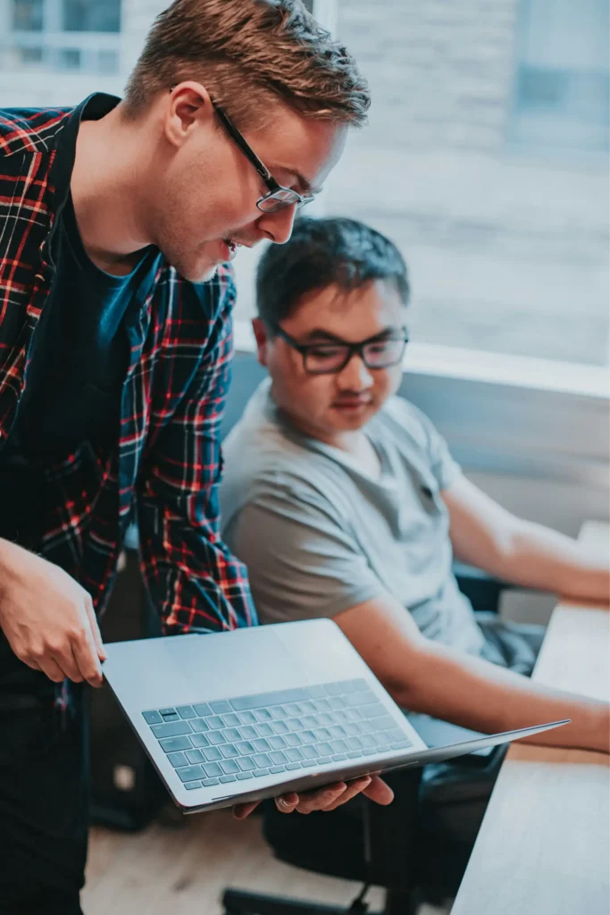 Student being show something on a laptop