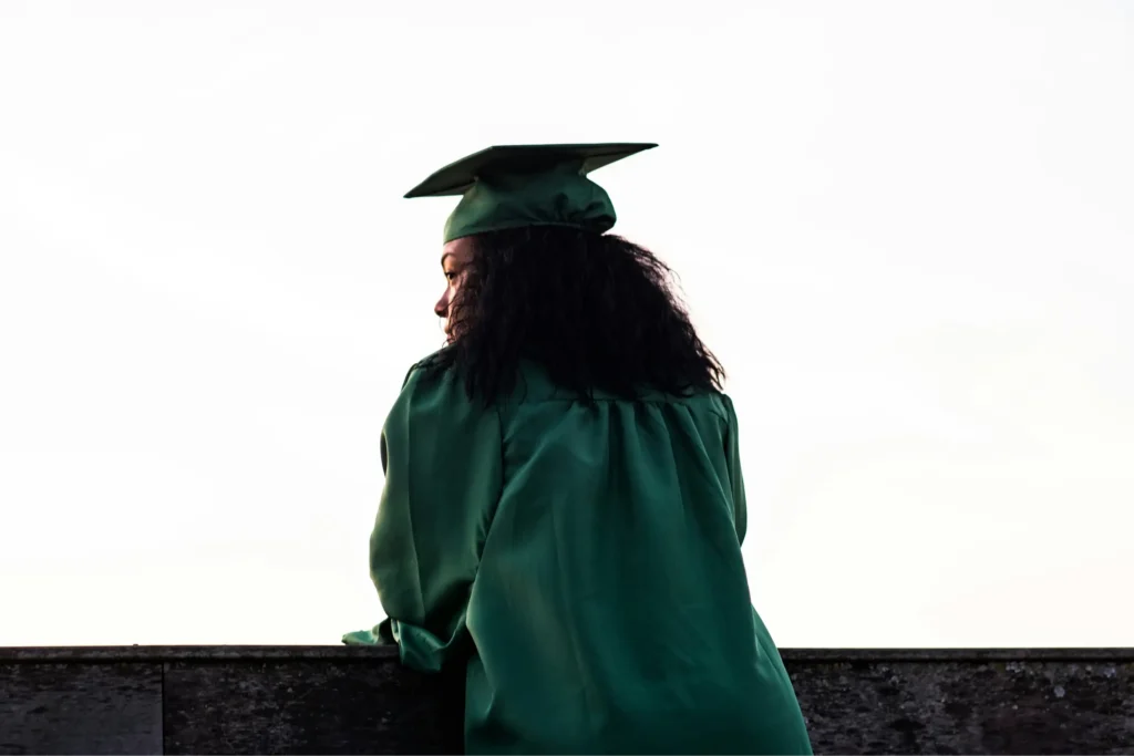 Rear view student in green cap and gown