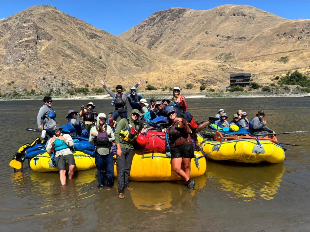 Student group photo on river with river rafts