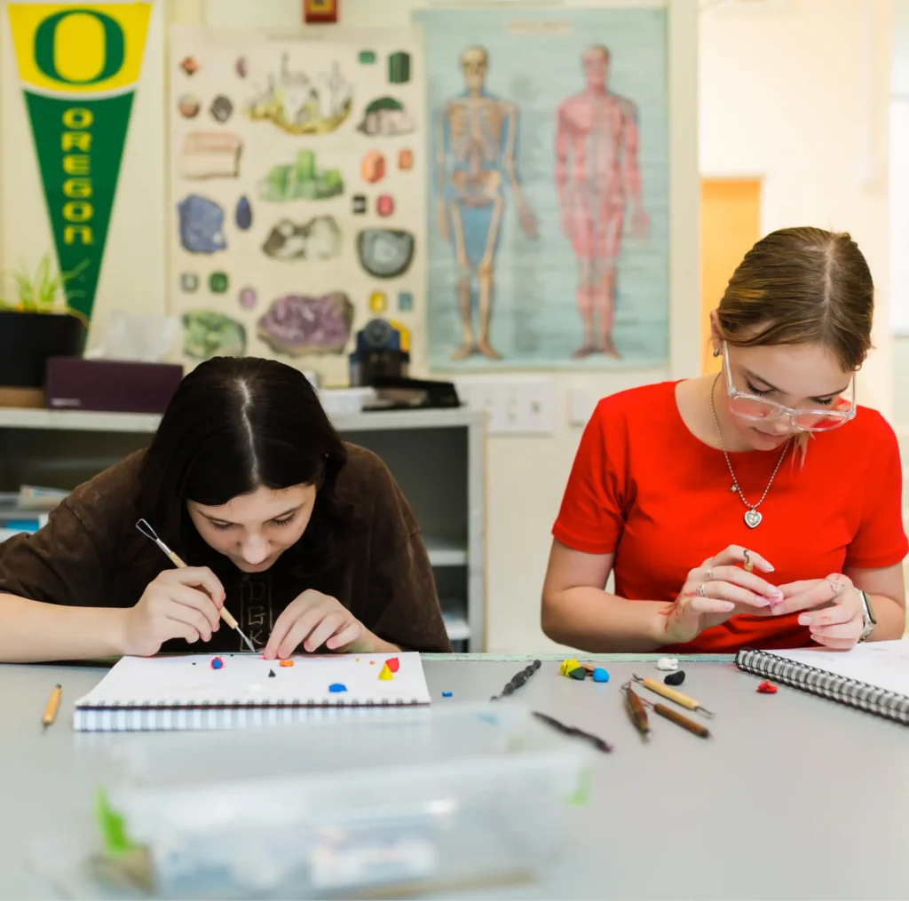 Two students working with colored clay